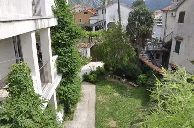 an alley in a city with buildings and trees at Apartments Ivanišević in Kotor