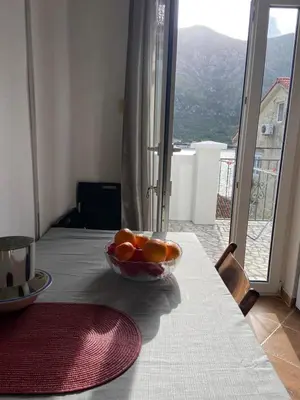 a bowl of oranges sitting on top of a table at Apartments Ivanišević in Kotor