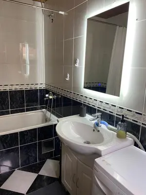 a bathroom with a sink and a mirror and a tub at Apartments Ivanišević in Kotor