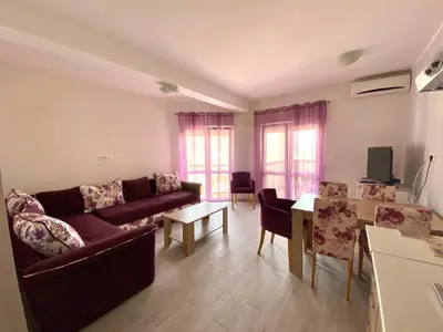 a living room with a couch and a table at Apartments Popović in Budva