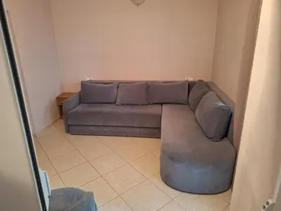 a living room with a couch in a room at Guest House Edita in Ulcinj