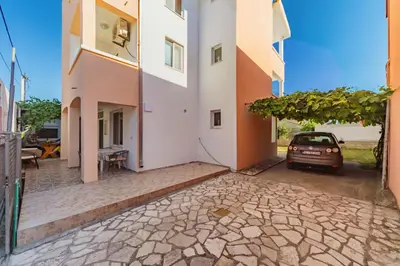 a car parked in the courtyard of a building at Guest House Edita in Ulcinj