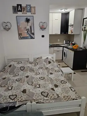 a bedroom with a bed and a kitchen at Seaview, just across the beach, Bečići in Becici