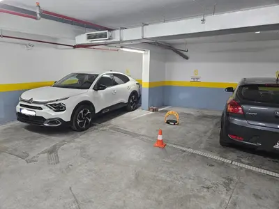 a parking garage with two cars parked in it at Seaview, just across the beach, Bečići in Becici