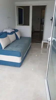 a bedroom with a bed in a room with a mirror at Seaview, just across the beach, Bečići in Becici