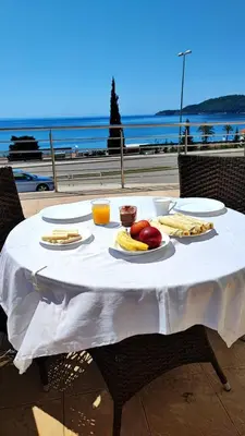 a table with food on it with a view of the ocean at Seaview, just across the beach, Bečići in Becici