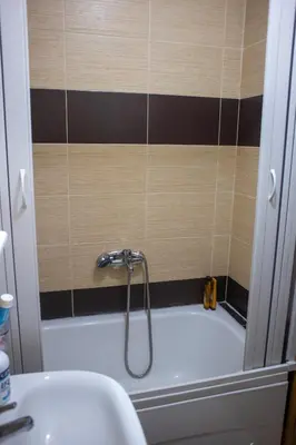 a bath tub with a shower in a bathroom at Apartment Marija in Podgorica