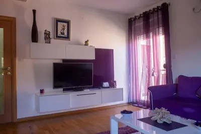 a living room with a flat screen tv on a entertainment center at Apartment Marija in Podgorica