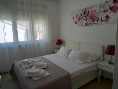 a bedroom with a bed with towels on it at Solaris Apartments in Budva
