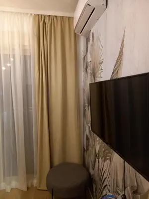 a living room with a television and a window at Solaris Apartments in Budva
