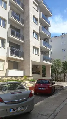 two cars parked in front of a building at Solaris Apartments in Budva
