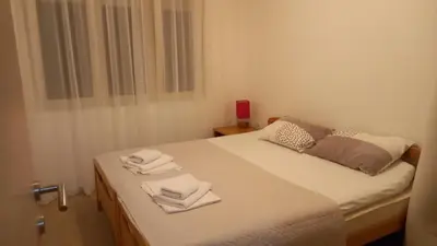 a bedroom with a bed with towels on it at Solaris Apartments in Budva
