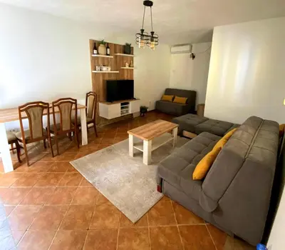 a living room with a couch and a table at Apartman Maslina in Podgorica