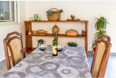 a table with two glasses of wine on it at Apartman Maslina in Podgorica