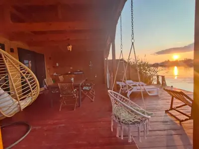 a porch of a house with chairs and a table at Sojenica Tamara in Ulcinj