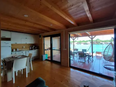a kitchen and dining room with a view of the water at Sojenica Tamara in Ulcinj