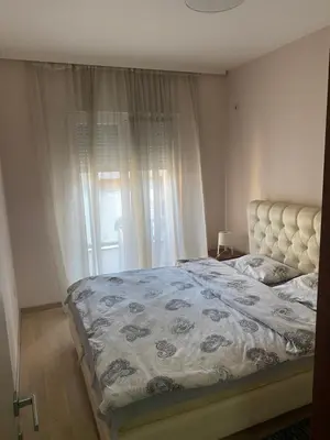 a bedroom with a bed and a window at Apartment City Kvart Podgorica in Podgorica