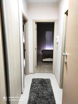 a hallway with a door leading into a room at Apartment City Kvart Podgorica in Podgorica