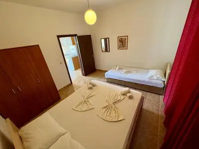 a small room with two beds and a table at Apartments Marniković in Ulcinj