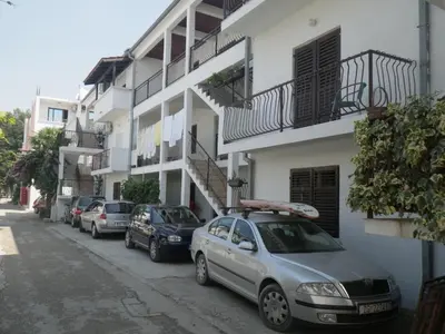 a row of cars parked in front of a building at Apartments Marniković in Ulcinj