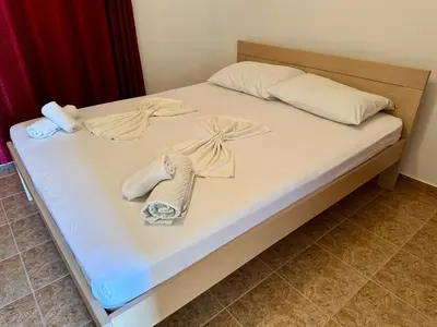 a bed with towels and towels on it at Apartments Marniković in Ulcinj