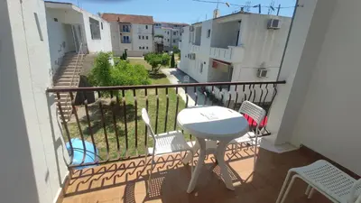 a balcony with a table and chairs on it at Apartments Marniković in Ulcinj