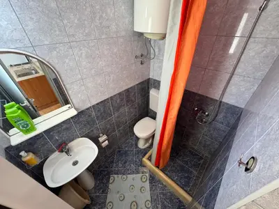 a small bathroom with a sink and a toilet at Apartments Marniković in Ulcinj