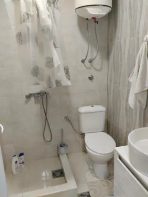 a bathroom with a toilet and a sink at HM Apartmani in Bar