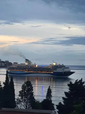 a large cruise ship sitting in the water at HM Apartmani in Bar