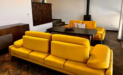a living room with a yellow couch and a table at Beach Villa Žukovica in Radanovići