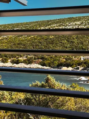 a view of a river through a fence at Beach Villa Žukovica in Radanovići