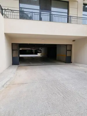 an empty parking garage under a building with a balcony at Fantastic new centre apartment in Podgorica