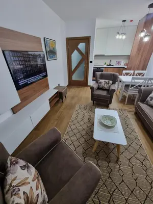 a living room with a couch and a coffee table at Fantastic new centre apartment in Podgorica