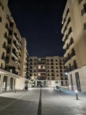 an empty parking lot in front of two large buildings at Fantastic new centre apartment in Podgorica