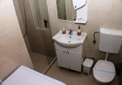 a bathroom with a toilet and a sink and a shower at Apartments Popovic in Kotor