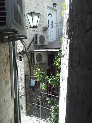 an alley with a balcony and a building at Apartments Popovic in Kotor
