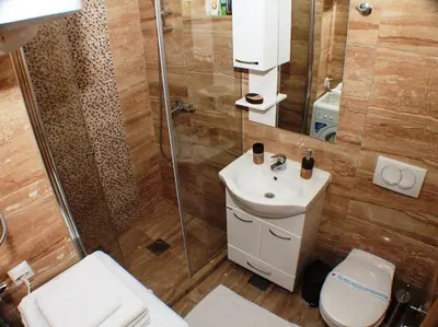 a bathroom with a shower and a toilet and a sink at Apartments Popovic in Kotor