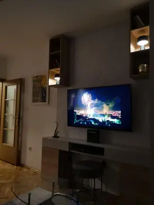 a living room with a flat screen tv on a wall at Studio apartment Art Zone in Podgorica