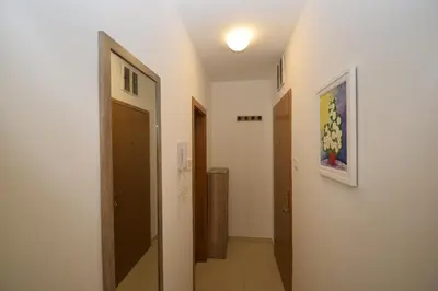 a hallway with a door and a painting on the wall at Studio apartment Art Zone in Podgorica
