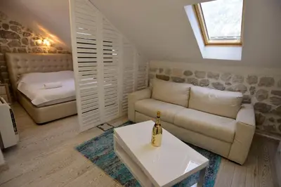 a living room with a couch and a bed at Waterfront Villa in Muo in Kotor