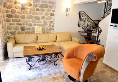a living room with a couch and a table at Waterfront Villa in Muo in Kotor