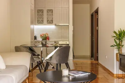 a living room with a table and a couch at Apartment Poetica Del Mare, Budva, Bečići in Becici