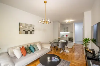 a living room with a couch and a table at Apartment Poetica Del Mare, Budva, Bečići in Becici