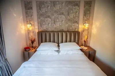a bedroom with a large bed with two night stands at Apartment Poetica Del Mare, Budva, Bečići in Becici