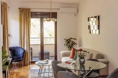 a living room with a couch and a table at Apartment Poetica Del Mare, Budva, Bečići in Becici