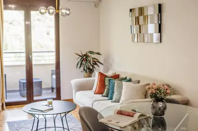 a living room with a couch and a table at Apartment Poetica Del Mare, Budva, Bečići in Becici