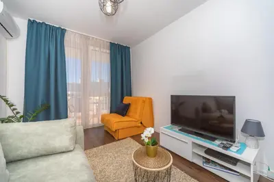 a living room with a couch and a television at Aloha Apartman in Bar