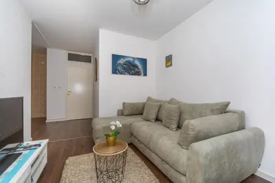 a living room with a couch and a tv at Aloha Apartman in Bar