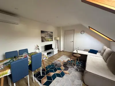 a living room with a couch and a table at Apartman Vucinic in Cetinje
