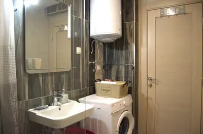 a bathroom with a toilet and a sink and a mirror at Yeshill Homes in Budva